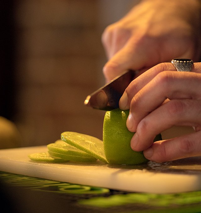 Fresh lime being sliced for drinks